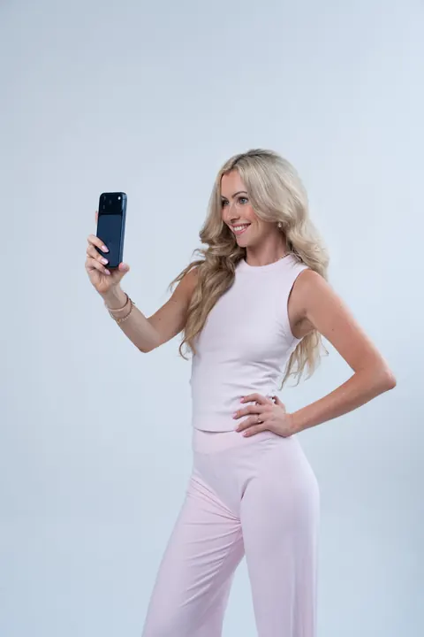 Olivia Malcher hält ein Smartphone hoch und filmt sich selbst – UGC-Videos entstehen mit dem Handy